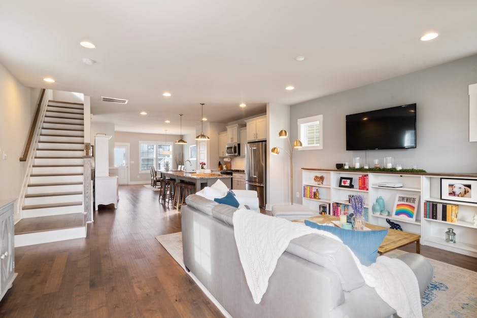 Bright and spacious modern living room with open concept kitchen and dining area, ideal for interior design inspiration.