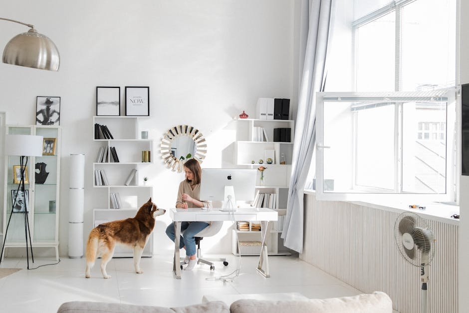 A woman in a stylish home office interacts with a dog, setting a serene and productive atmosphere.